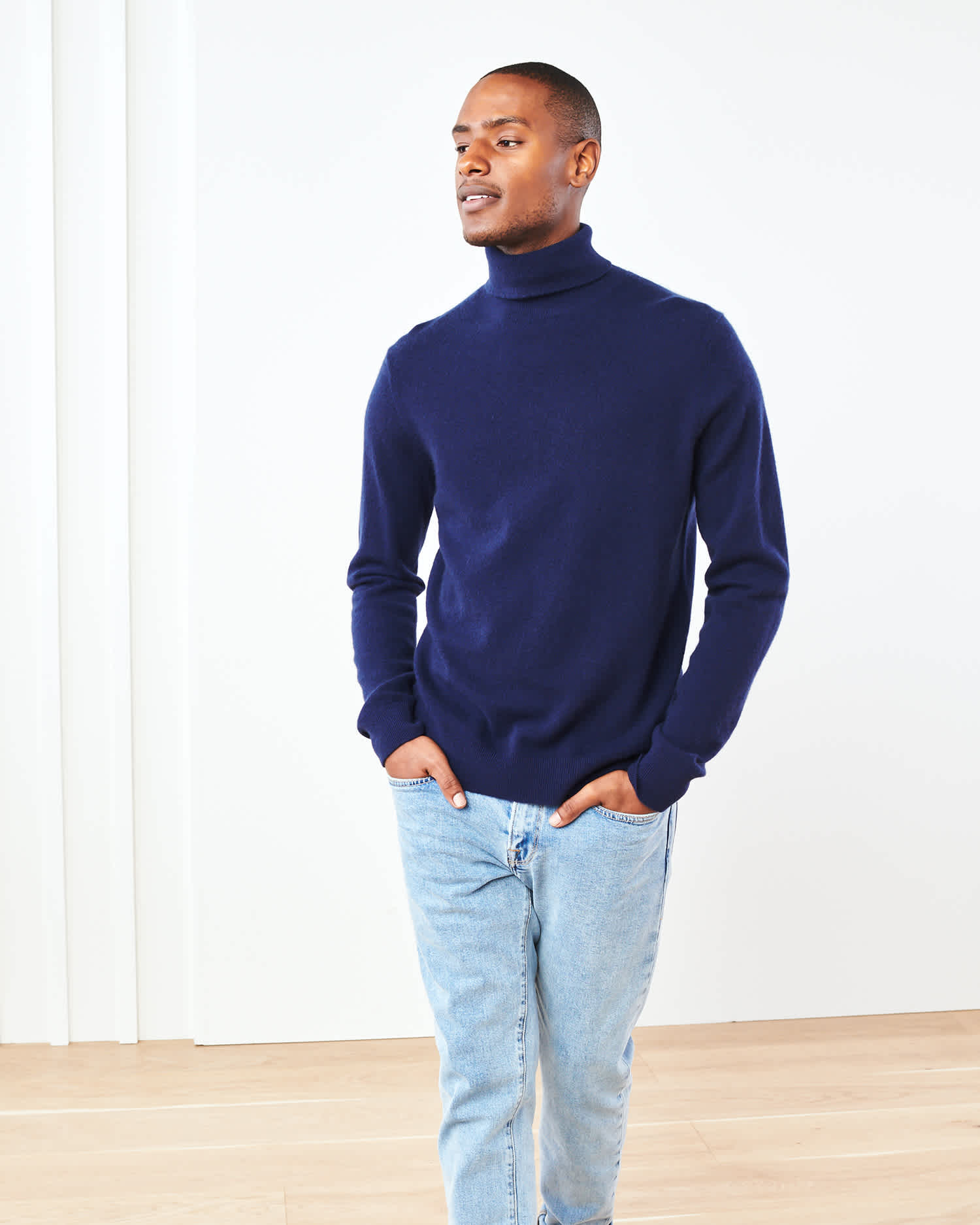 Man wearing navy men's cashmere turtleneck sweater front