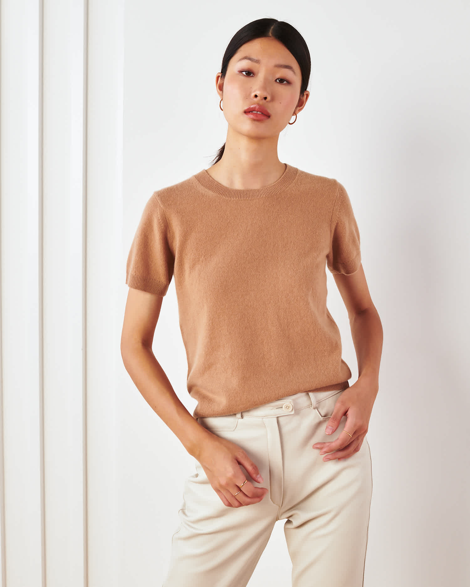 woman wearing camel cashmere tee standing