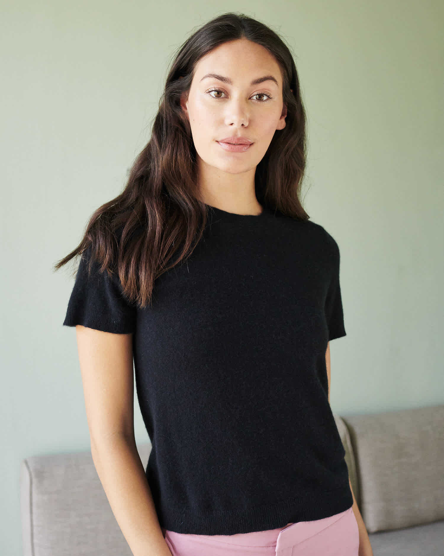 woman wearing black cashmere tee looking at the camera