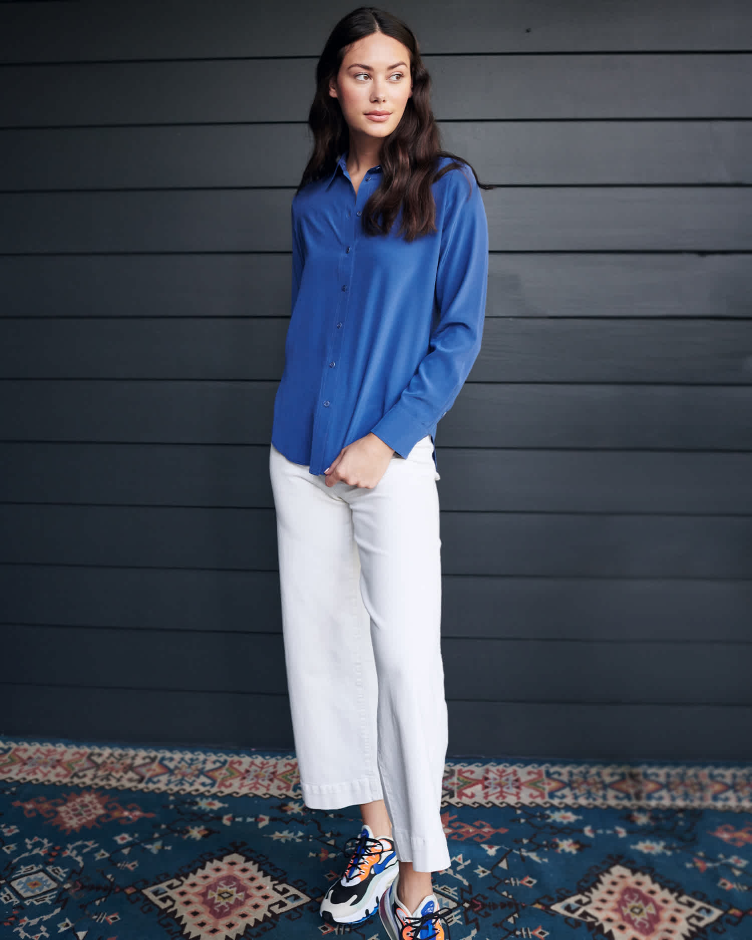 Woman wearing washable silk blouse in blue standing