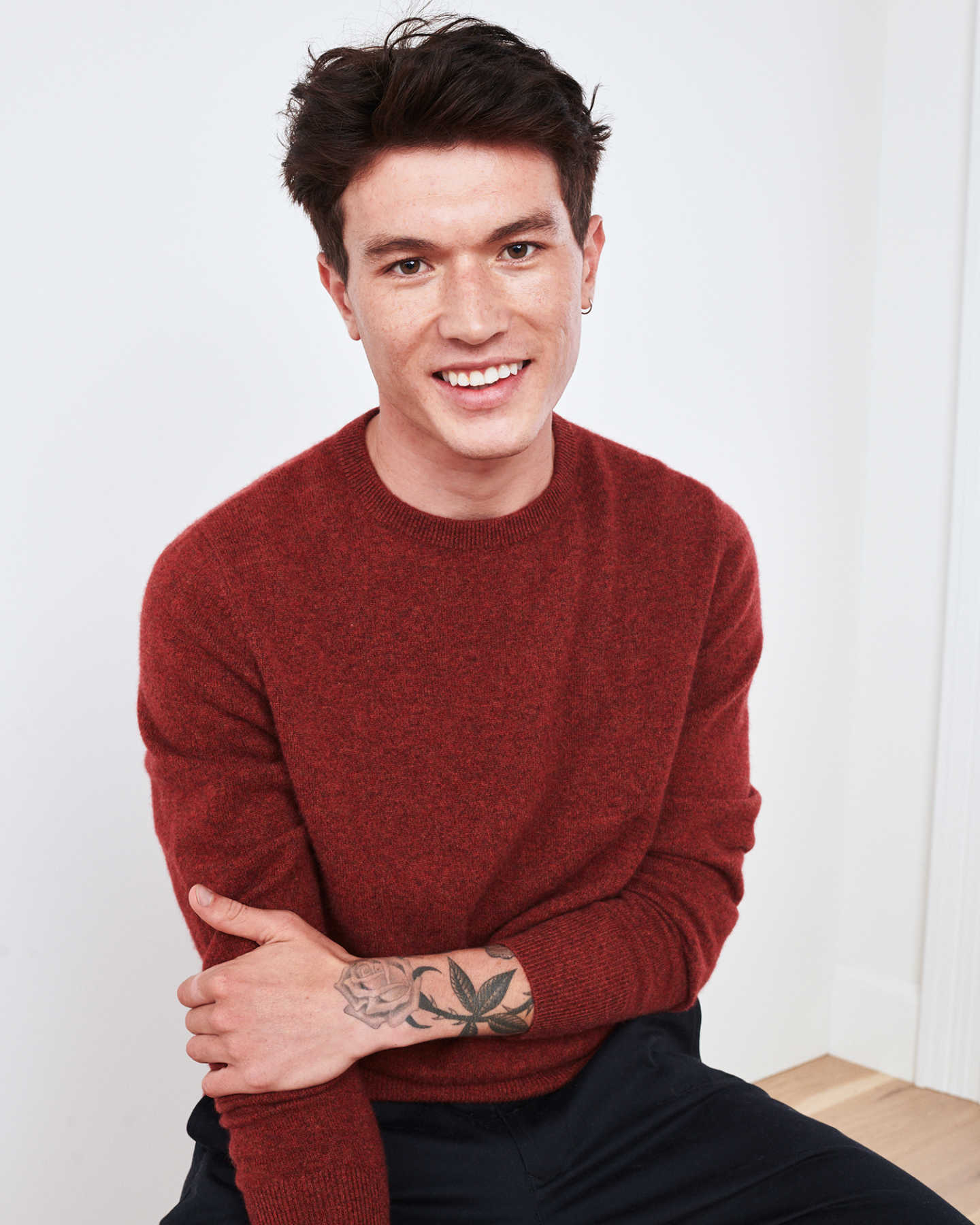 Man wearing red men's cashmere sweater smiling