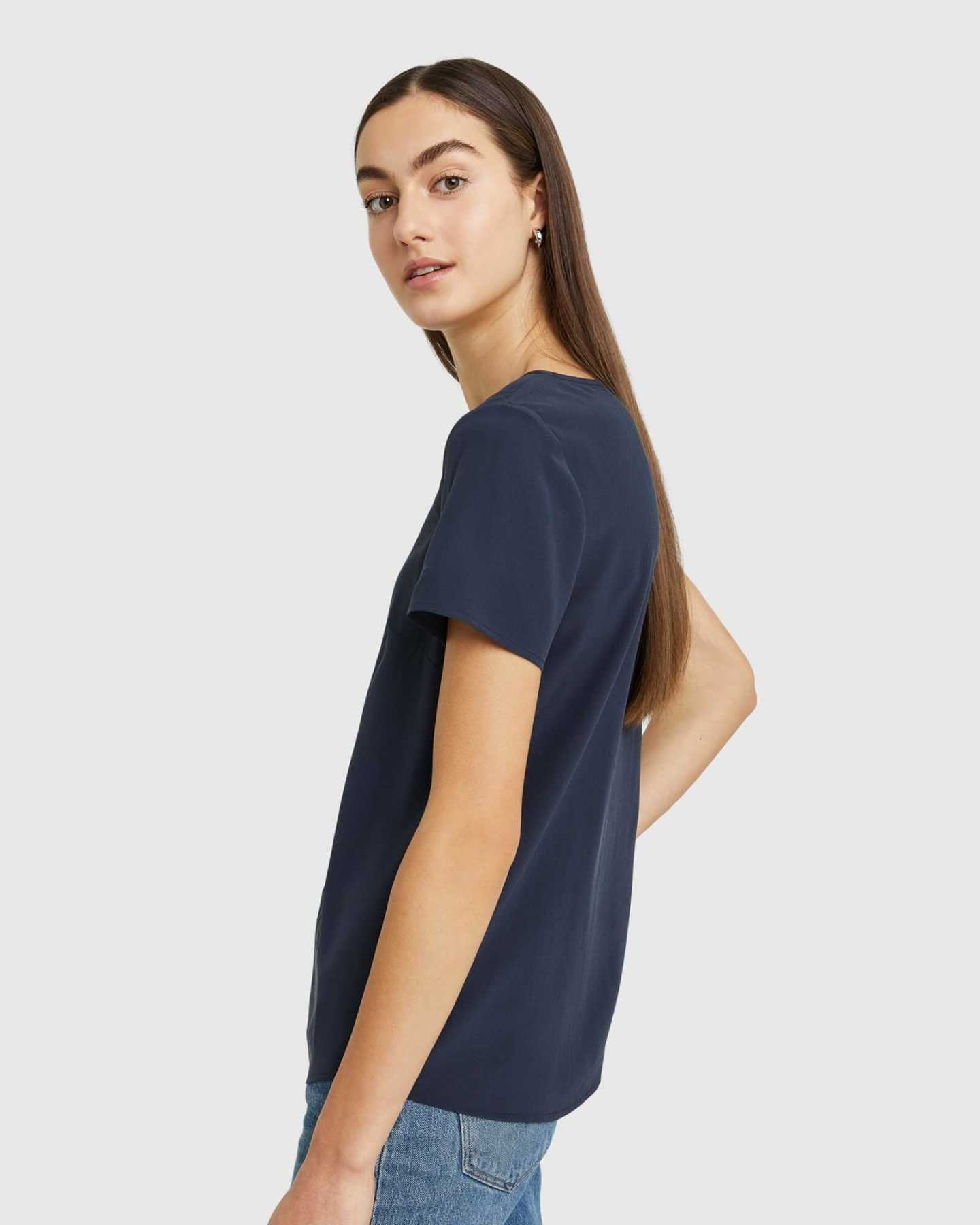 Woman wearing silk tee in navy from side