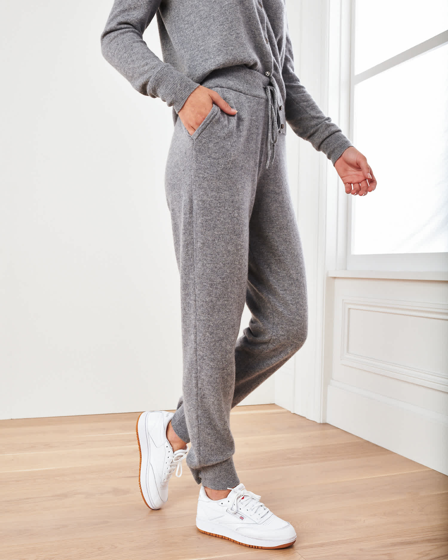 Woman wearing grey cashmere sweatpants & cashmere joggers