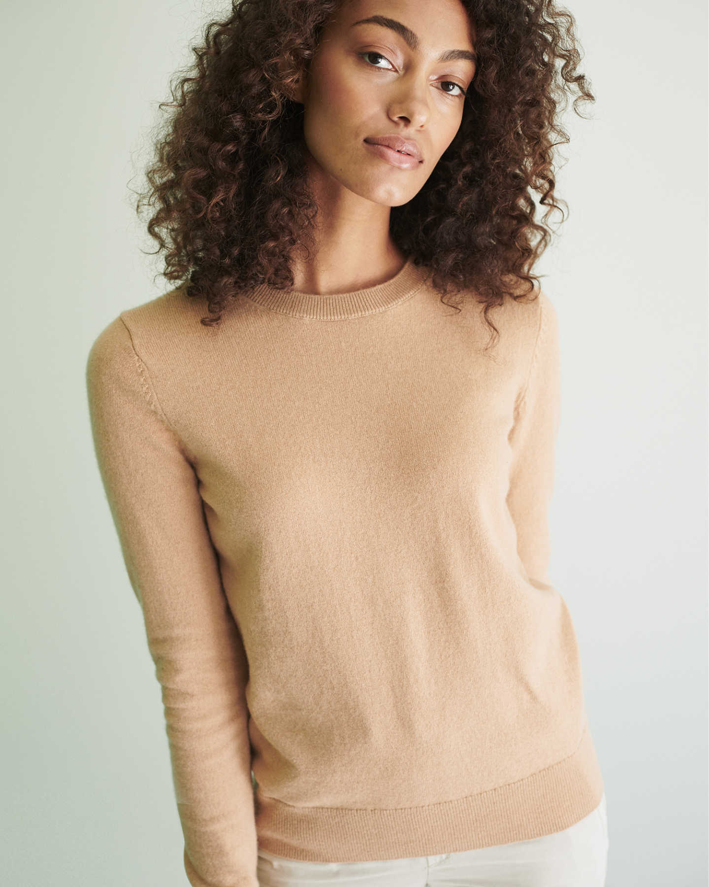 Woman wearing camel cashmere sweater