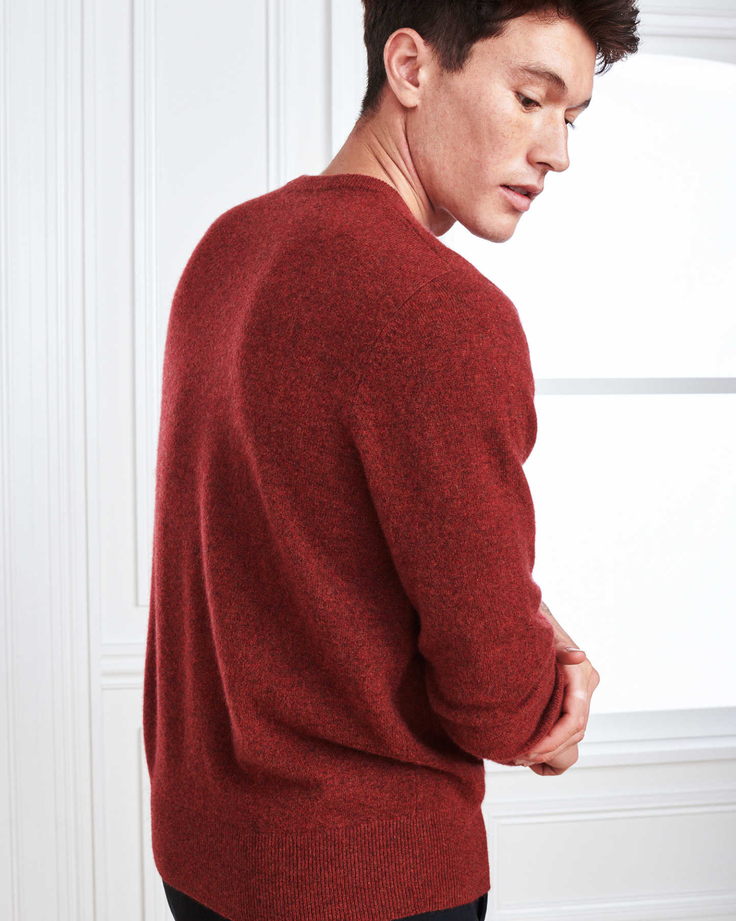 Man wearing red men's cashmere sweater from back