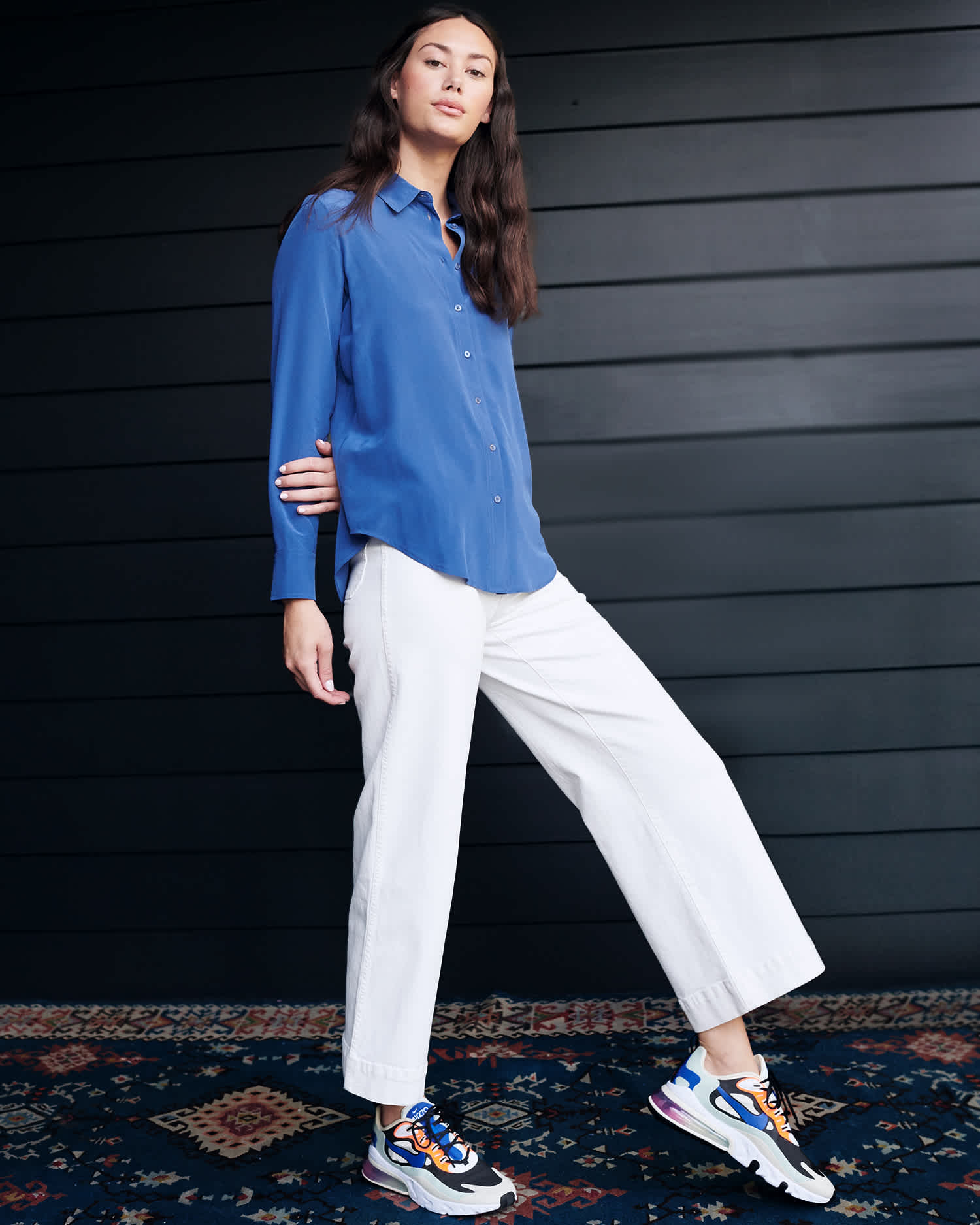 Woman wearing washable silk blouse in blue walking