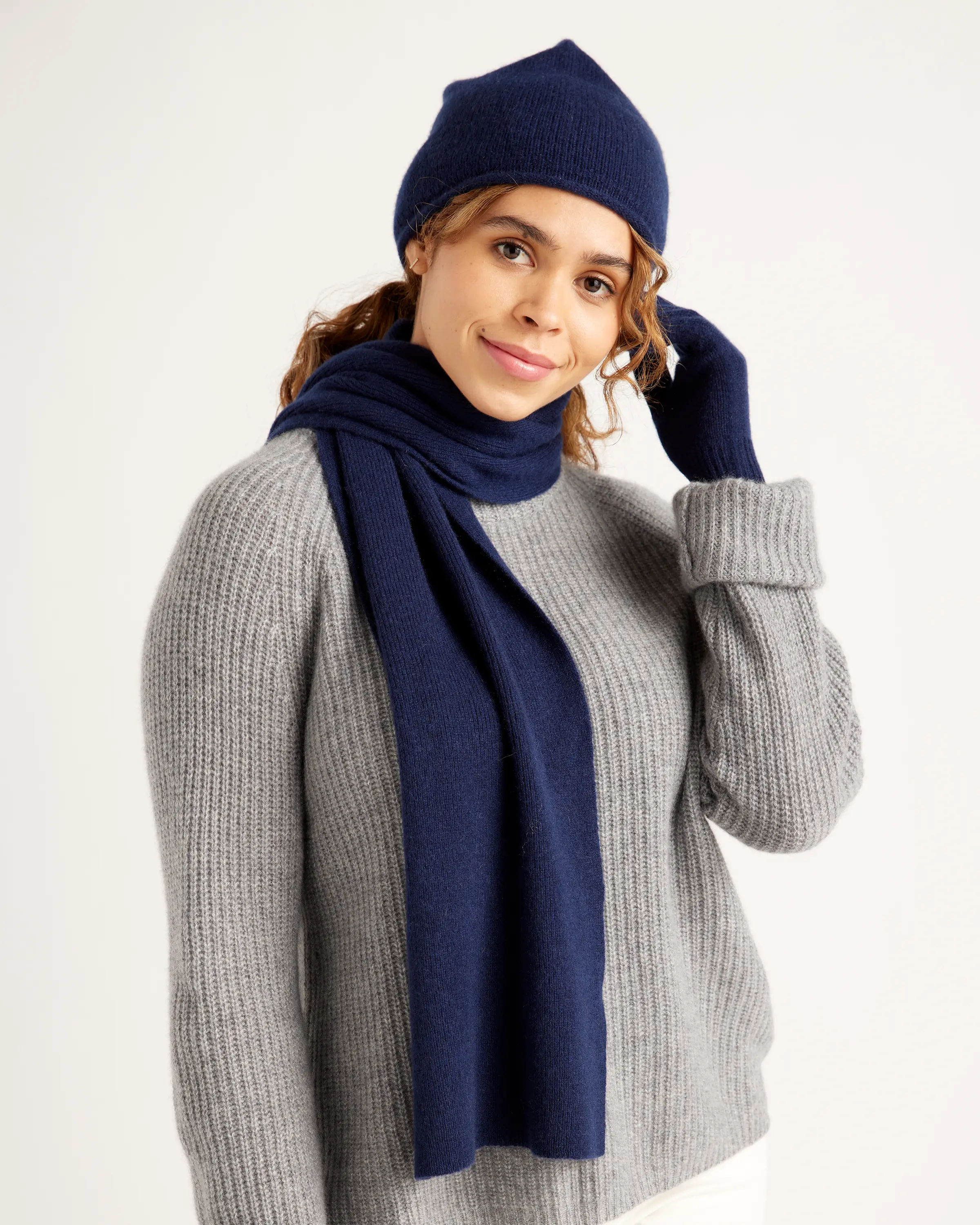 Person wearing a dark blue winter hat and scarf.