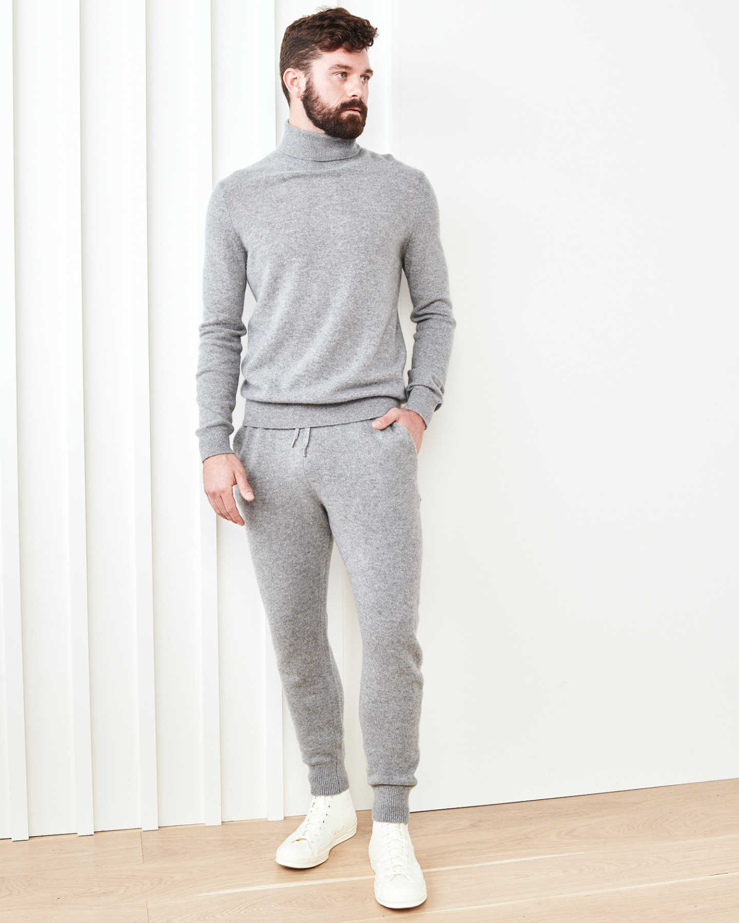 Man wearing cashmere men's cashmere joggers / cashmere sweatpants in grey and grey men's cashmere sweater