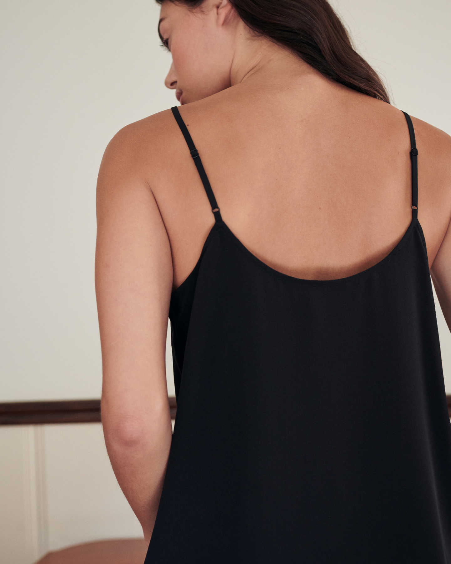 woman wearing silk camisole in black from back