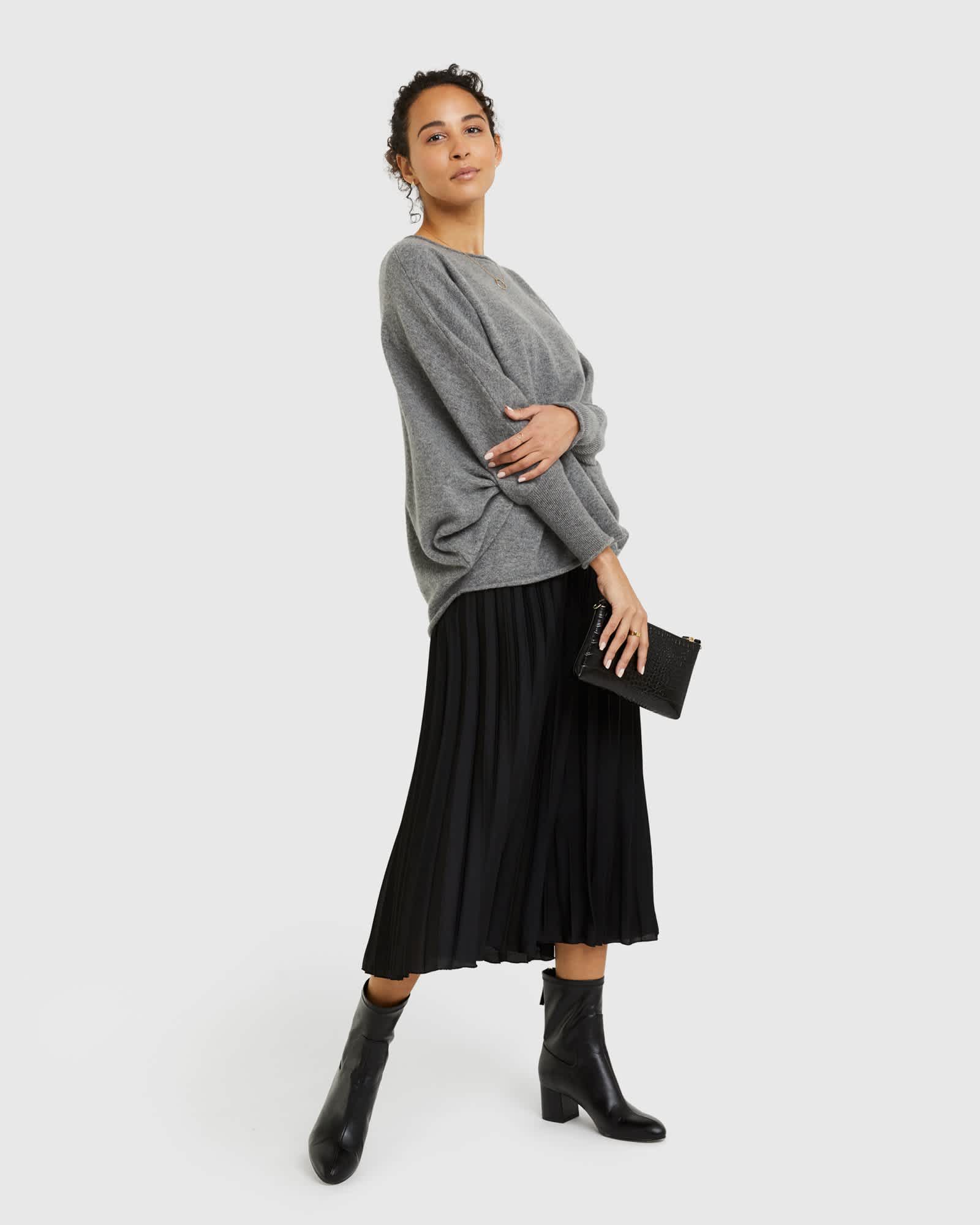 Woman wearing batwing sweater made from cashmere in grey from the front also