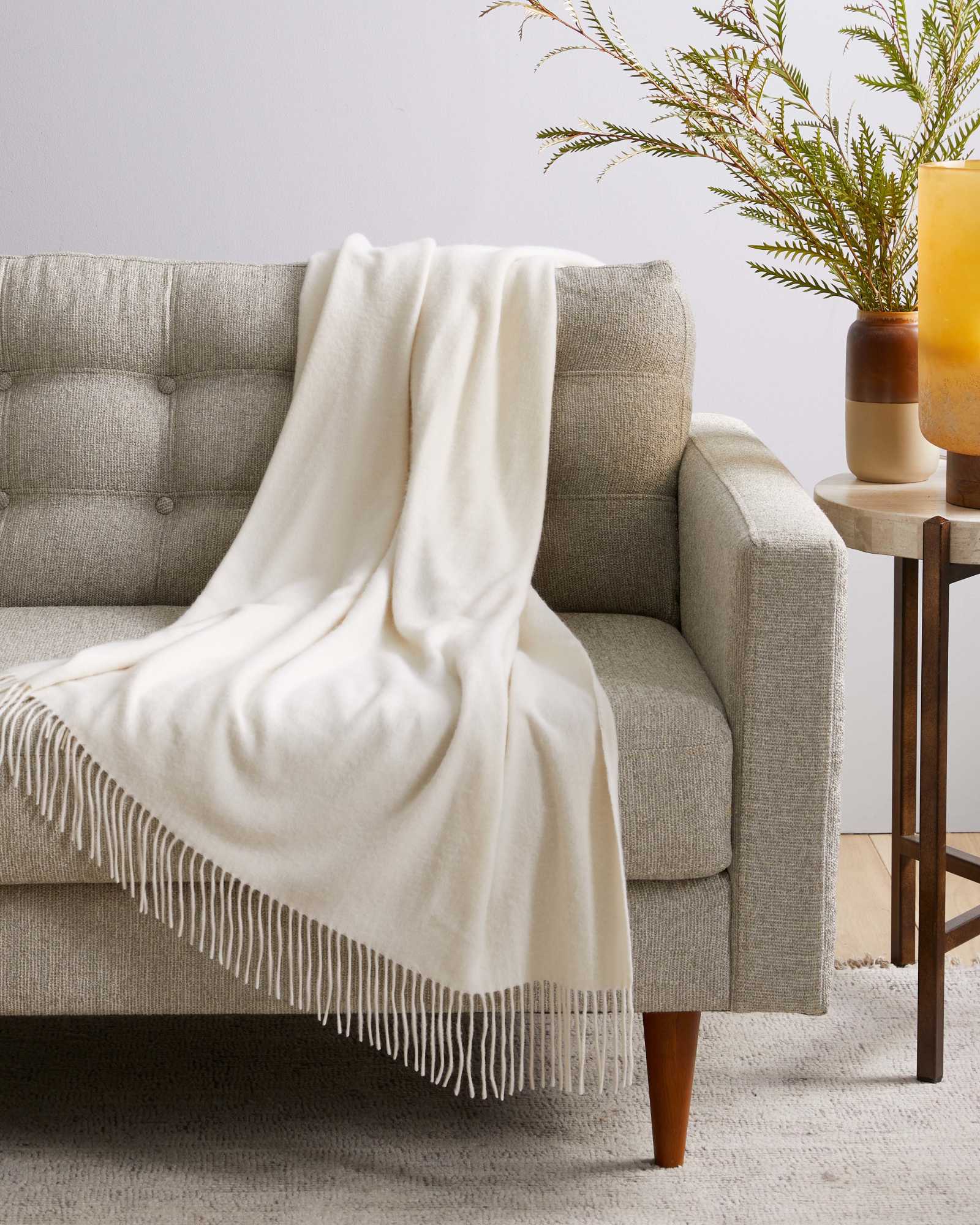 Cashmere throw blanket in ivory on chair