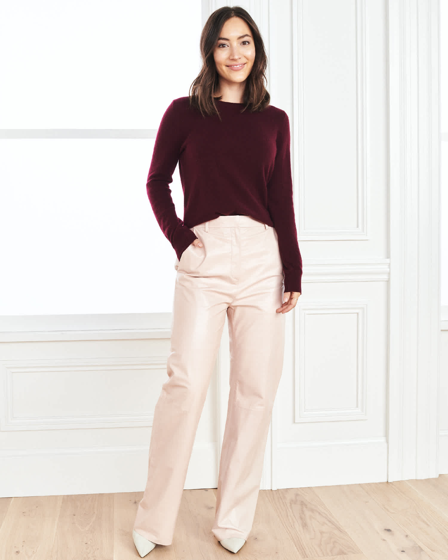 Woman wearing baby cashmere sweater in burgundy standing