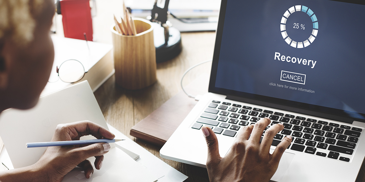 Woman on laptop recovering information 