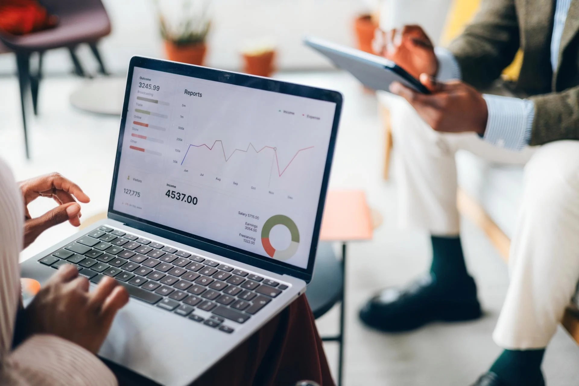 Business person looking at a reporting dashboard in a laptop. 