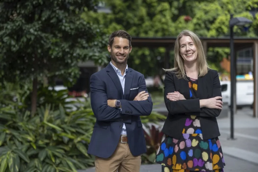 Professional-man-and-woman-standing-outside-with-arms-crossed