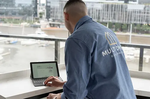 man-looking-at MYOB-dashboard-on-tablet