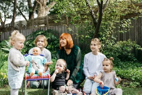 woman-in-garden-with-five-children