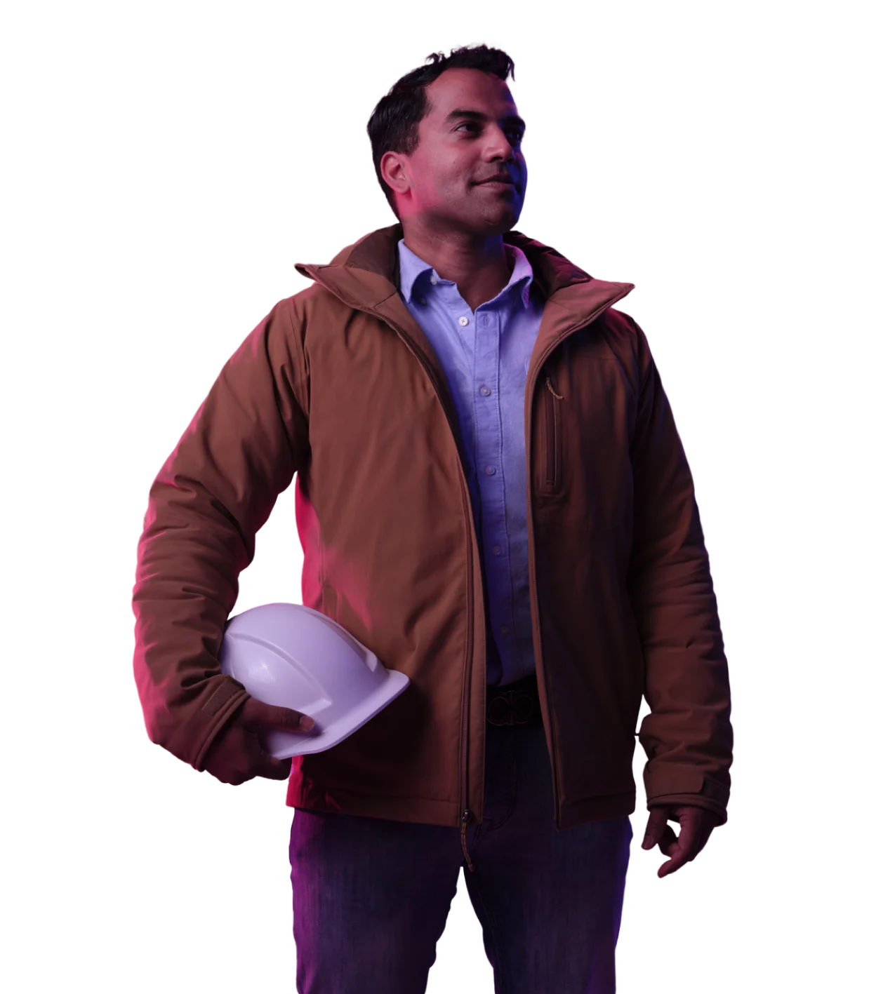 Person in brown jacket holding white safety helmet, wearing blue button-up shirt, illuminated by purple lighting.