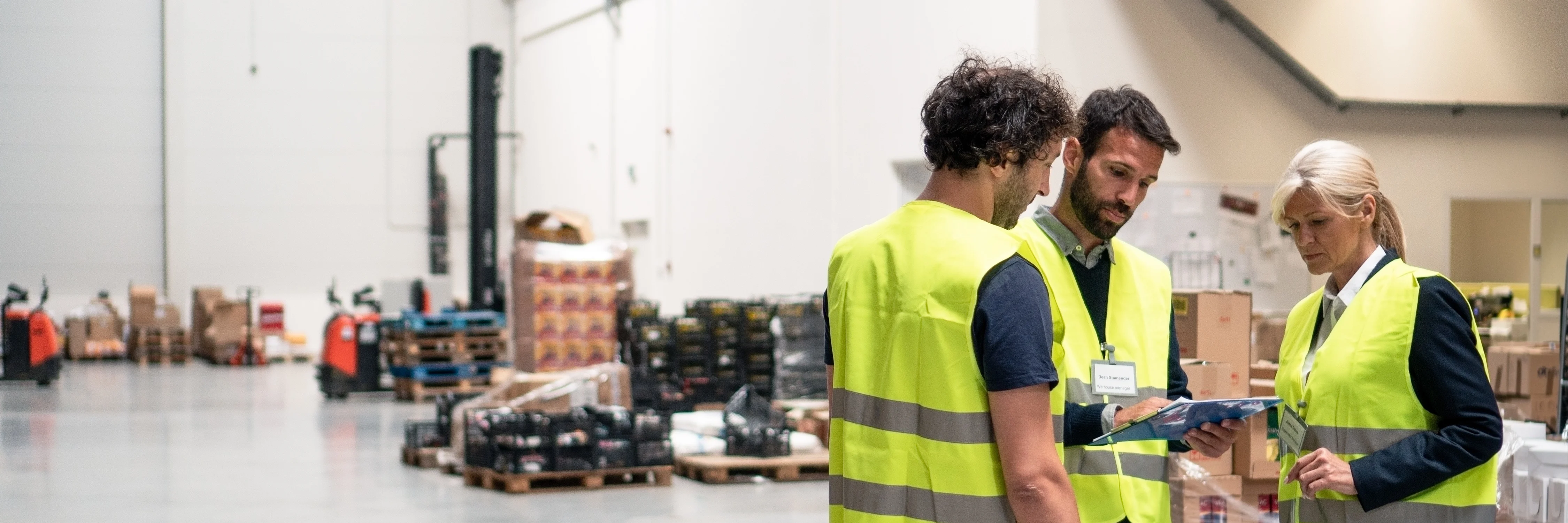 Warehouse workers using MYOB ERP software on a tablet.