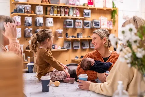 group-of-women-and-children-socialising-in-shop