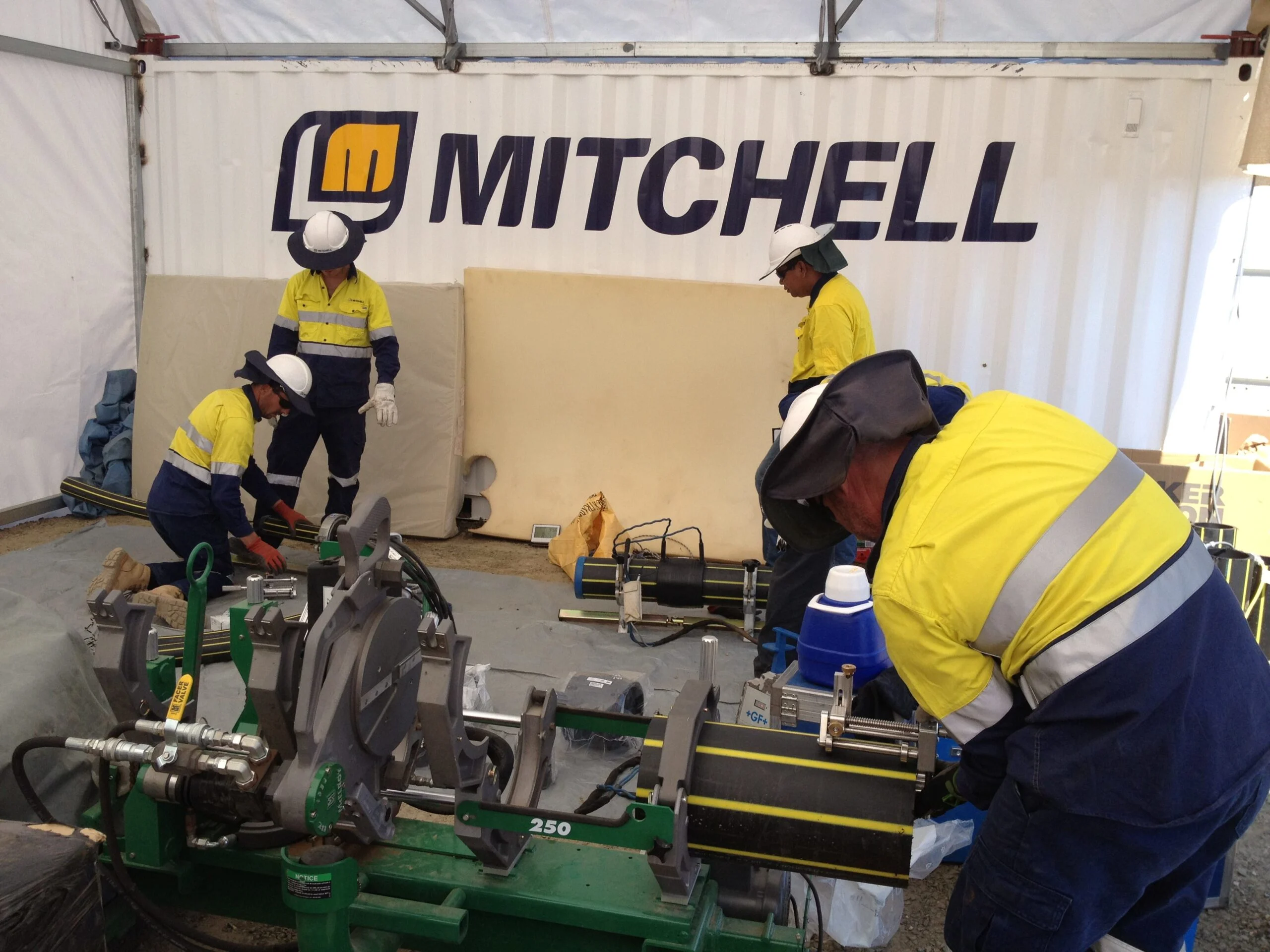 Three-construction-workers-having-on-site-meeting