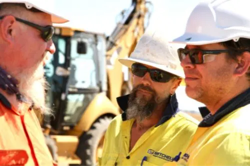 Three-construction-workers-having-on-site-meeting