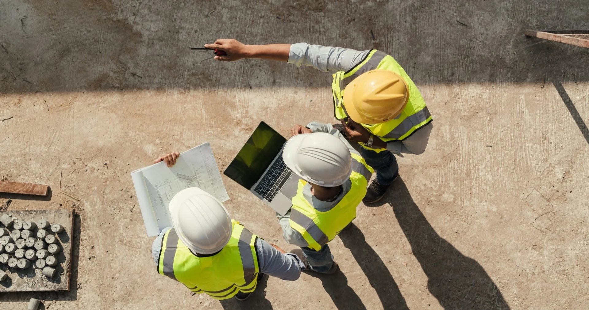 Project managers and construction workers on site looking at project plans