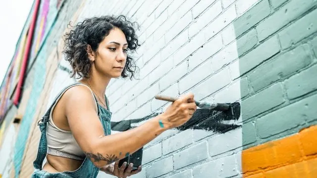 Artist painting outdoor mural 