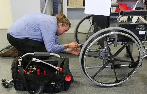 Young-man-servicing-wheelchair