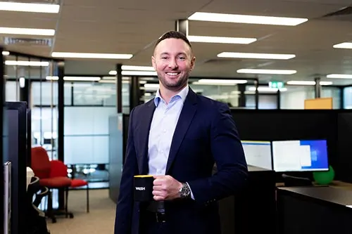 man-in-office-holding-coffee-cup