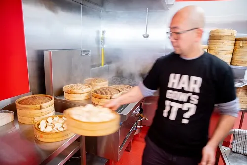 Man-in-commercial-kitchen-cooking-dumplings