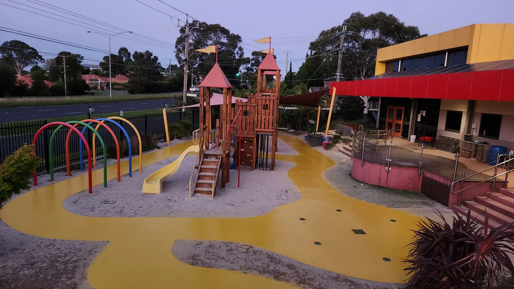 A children's playground at a daycare centre, with yellow flooring installed by Stellmann.