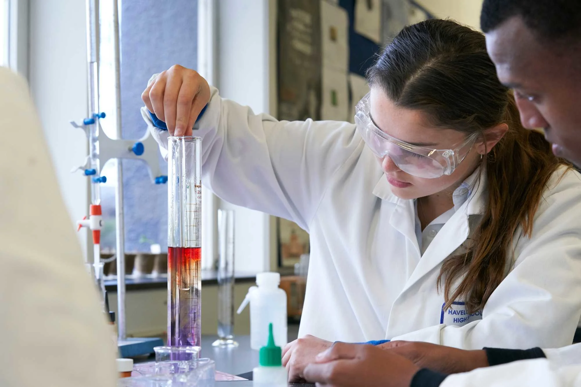 Schoolgirl-carrying-out-chemistry-experiment