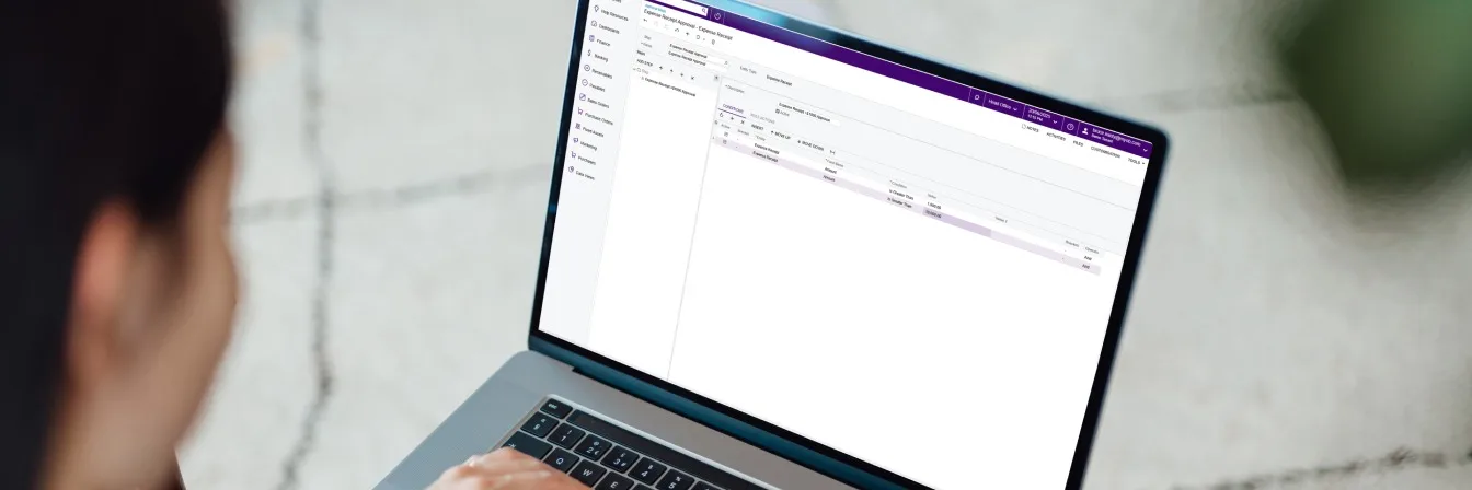 Person using laptop with a CRM displayed on screen.