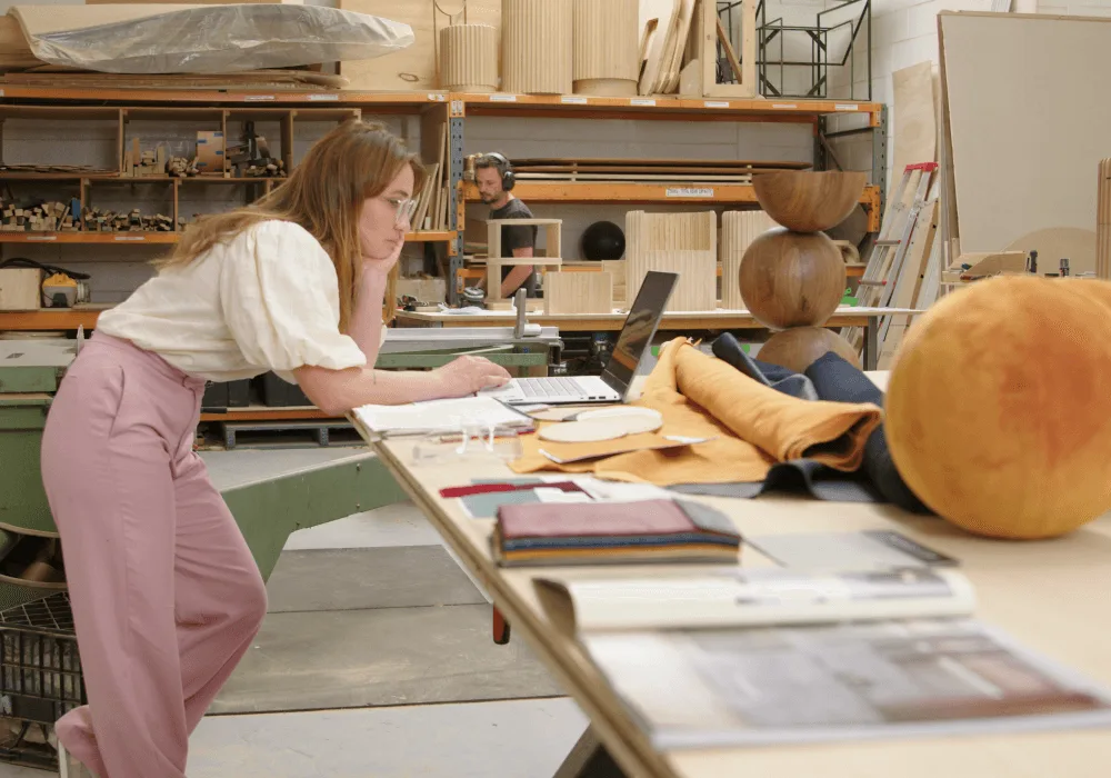 woman-at-standup-desk-looking-at designs