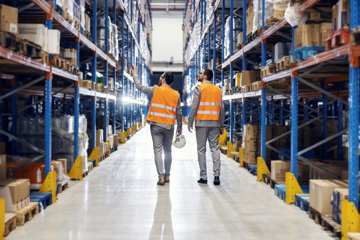 two-men-walking-through-warehouse