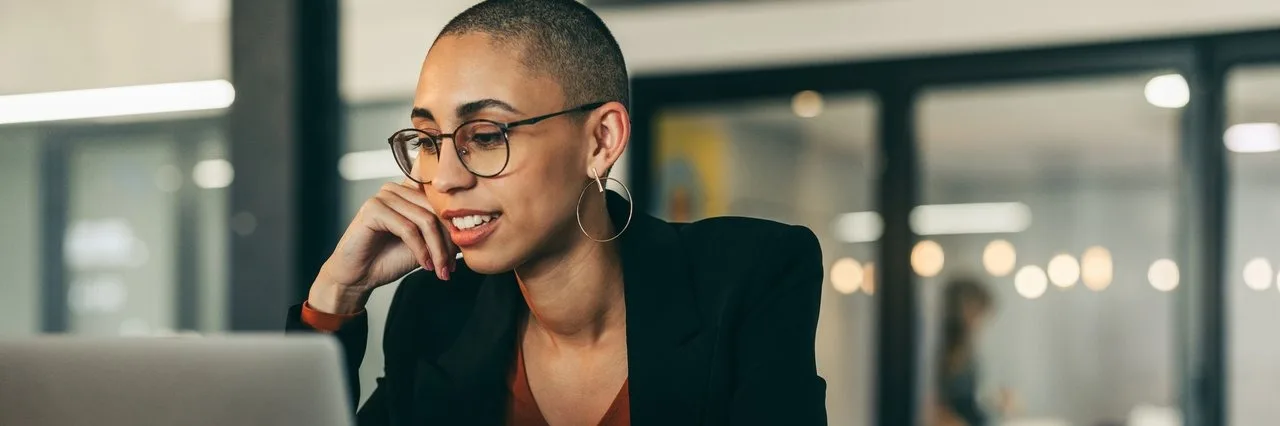 Young businesswoman attending a virtual meeting in a modern office