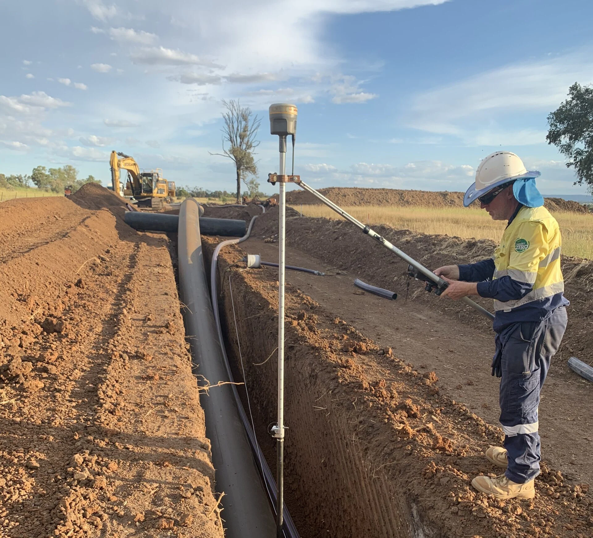 Two-construction-workers-laying-a-pipeline