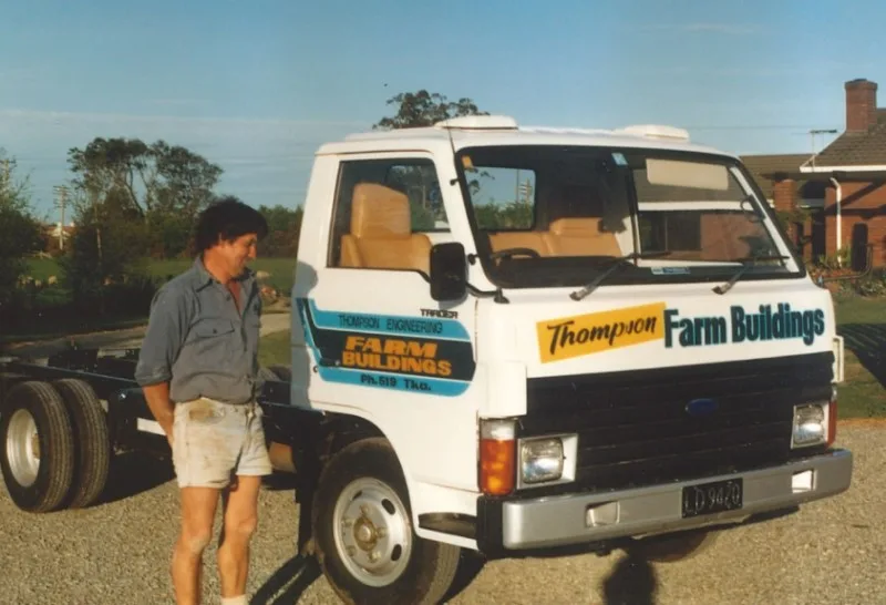 Man-standing-next-to-Thompson-vehicle