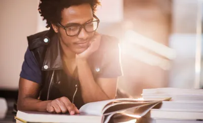 Image of a student reading a book