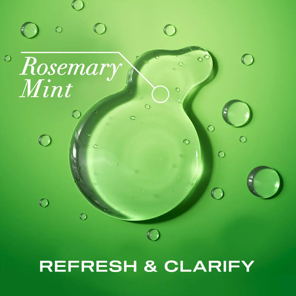 OGX® Rosemary Mint Extra Strength Shampoo product smear on a green background