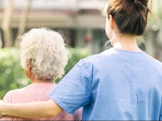 Woman with hand on shoulder of another woman