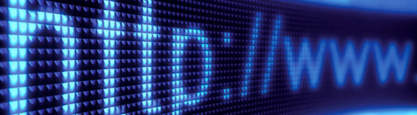 Close-up of a glowing blue digital screen displaying "http://www" in pixelated letters.