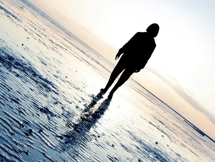 Mental Health Banner Image - Silhouette of a person on a beach