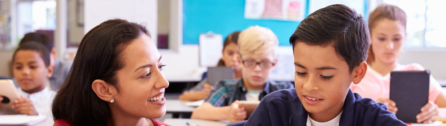 Teacher with a student in a classroom