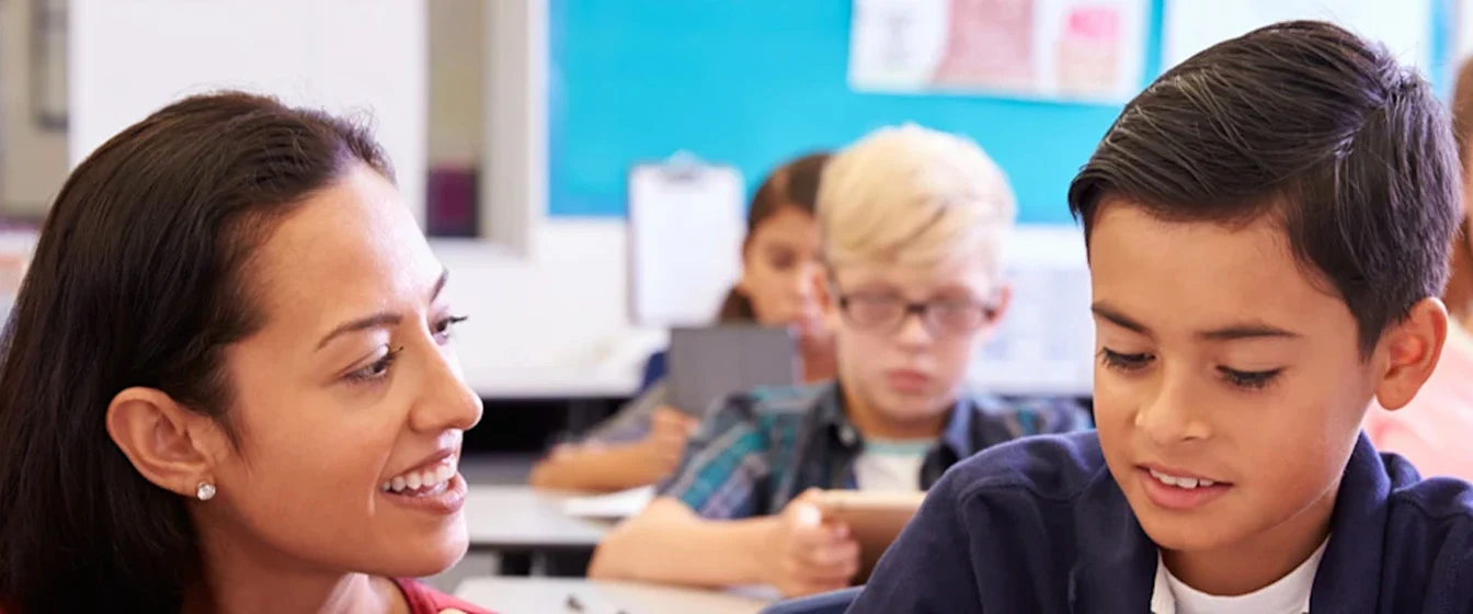 Teacher with a student in a classroom