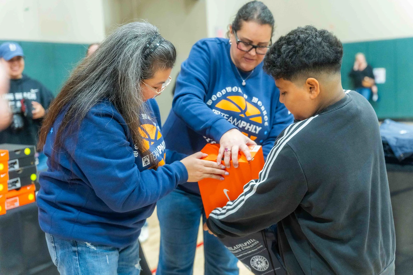 PHLY employees pack shoes for a child recipient. 