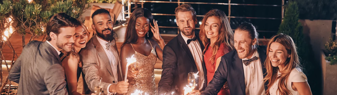 Image of crystal glasses full of champagne held by friends gathered at a one-day event.