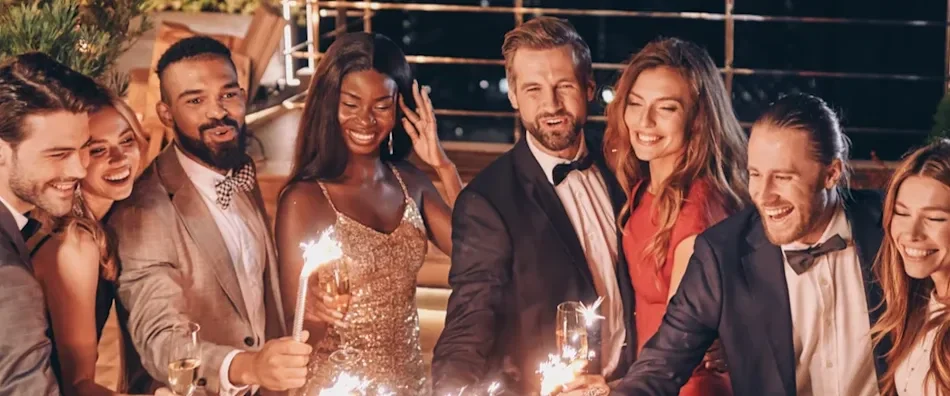 Image of crystal glasses full of champagne held by friends gathered at a one-day event. 