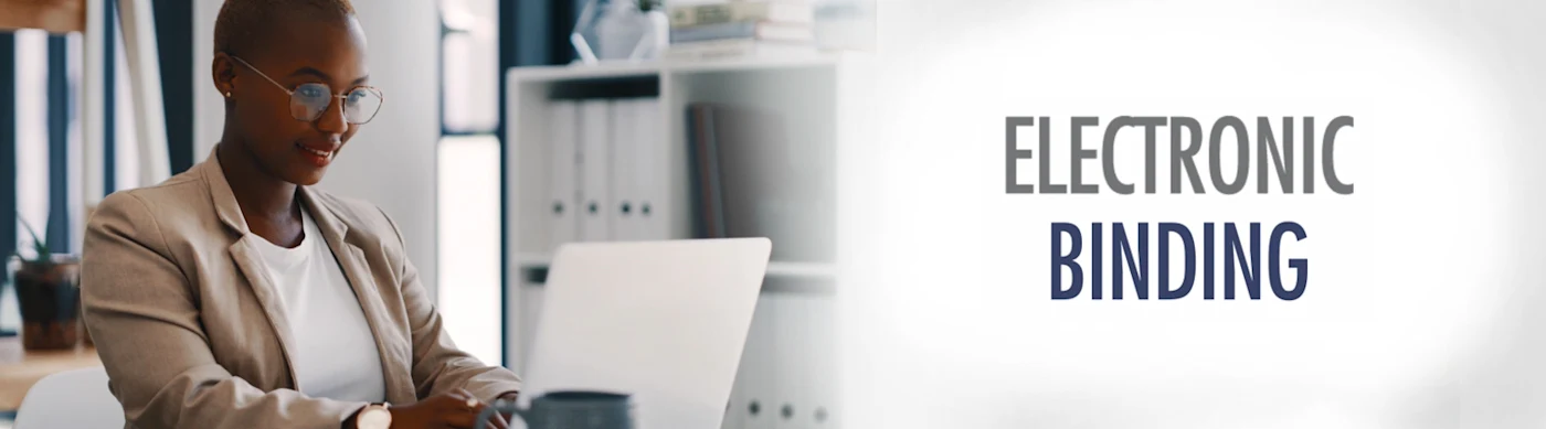 Woman works on a laptop. Text overlay: Electronic Binding